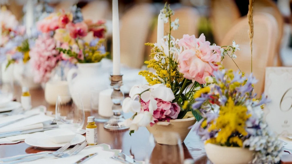 A reception table set with a soft pink tablescape