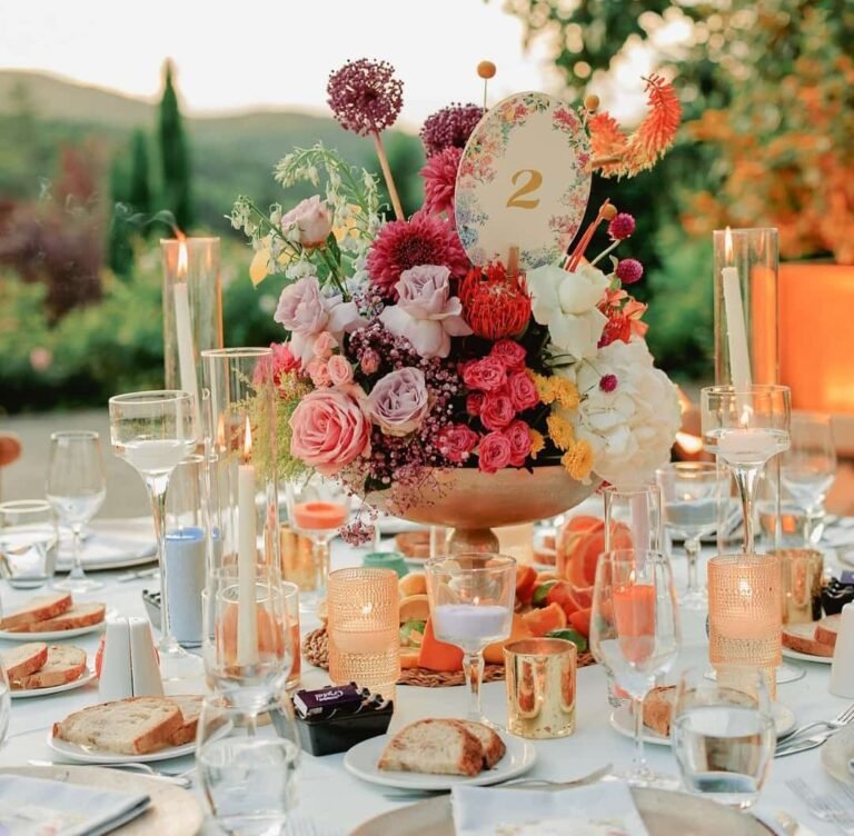 Outdoor wedding table with a floral centrepiece and glassware